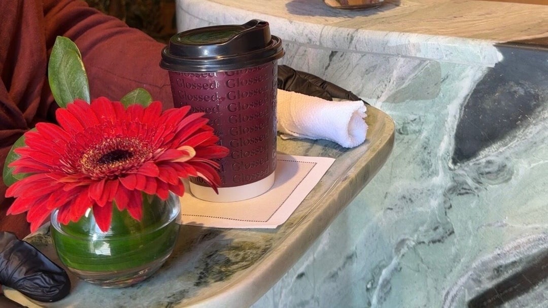 Branded Glossed coffee cup with fresh flowers at reception